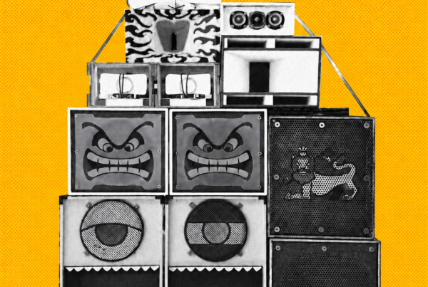 Bigbada Boom speaker stack on a full-bleed yellow-orange halftone background.