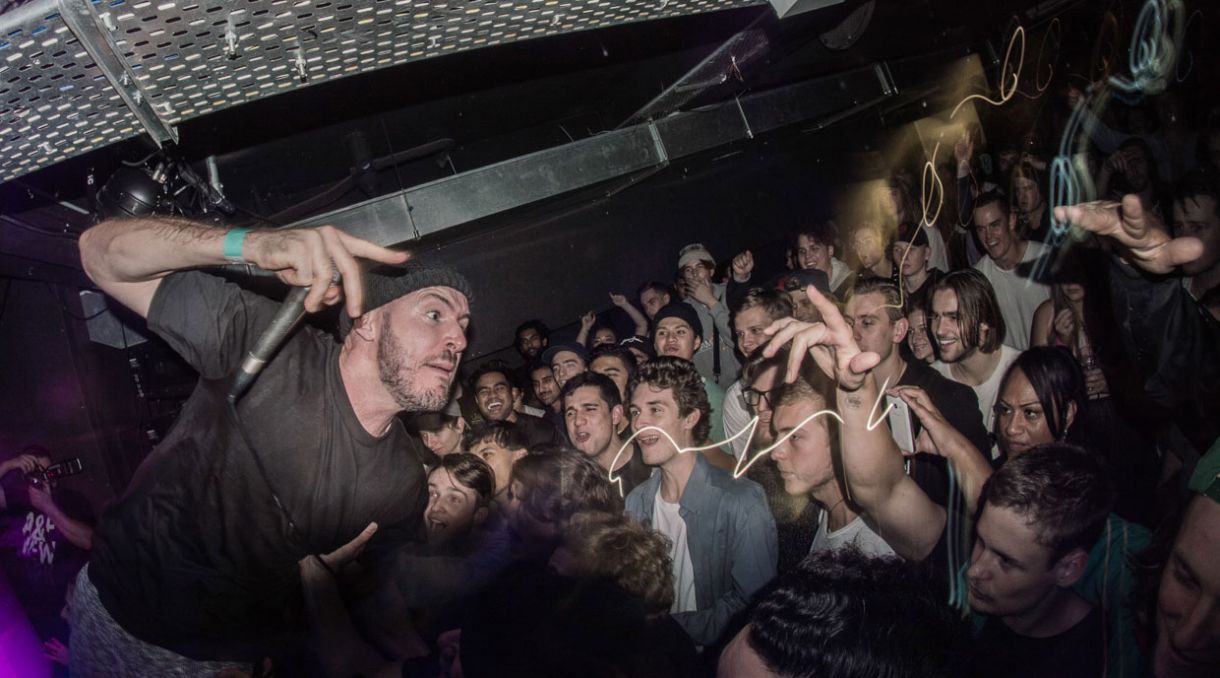 A packed crowd at an underground live music show in Auckland